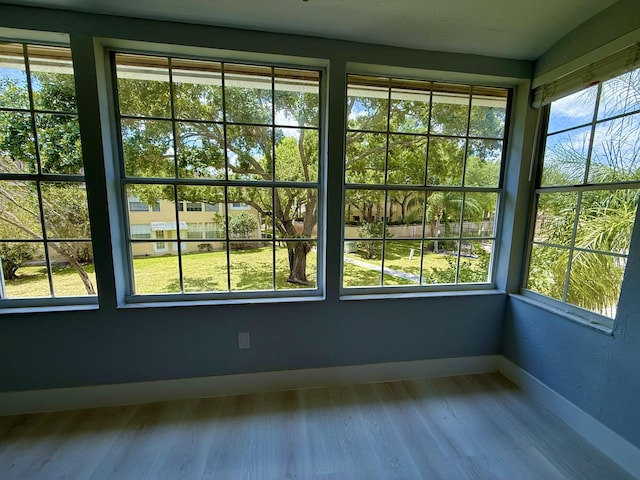 208 Palm Beach Trace Dr, Royal Palm Beach, FL 33411 - unfurnished sunroom with baseboards and wood finished floors