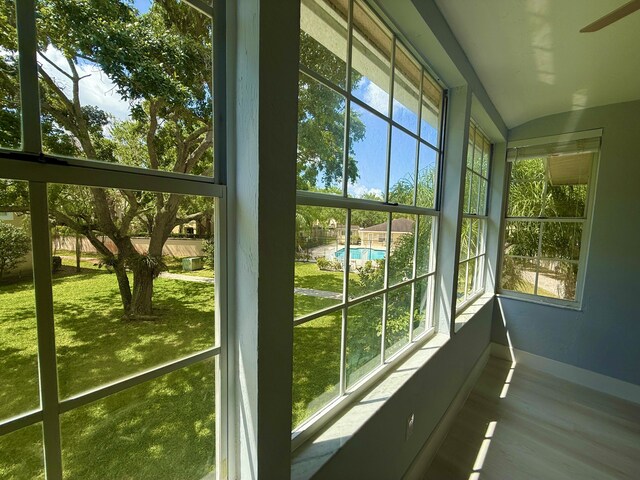 208 Palm Beach Trace Dr, Royal Palm Beach, FL 33411 - unfurnished sunroom with baseboards, wood finished floors, and healthy amount of natural light