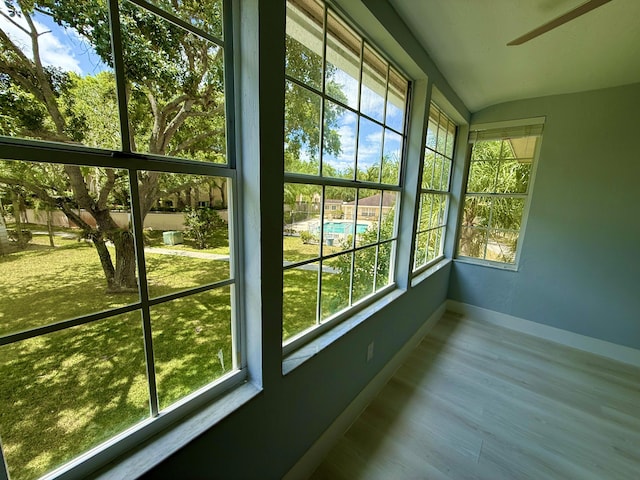 208 Palm Beach Trace Dr, Royal Palm Beach, FL 33411 - unfurnished sunroom with baseboards, plenty of natural light, wood finished floors, and lofted ceiling