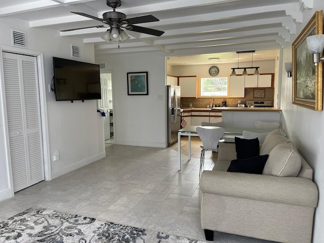 living area with beam ceiling, visible vents, ceiling fan, and baseboards