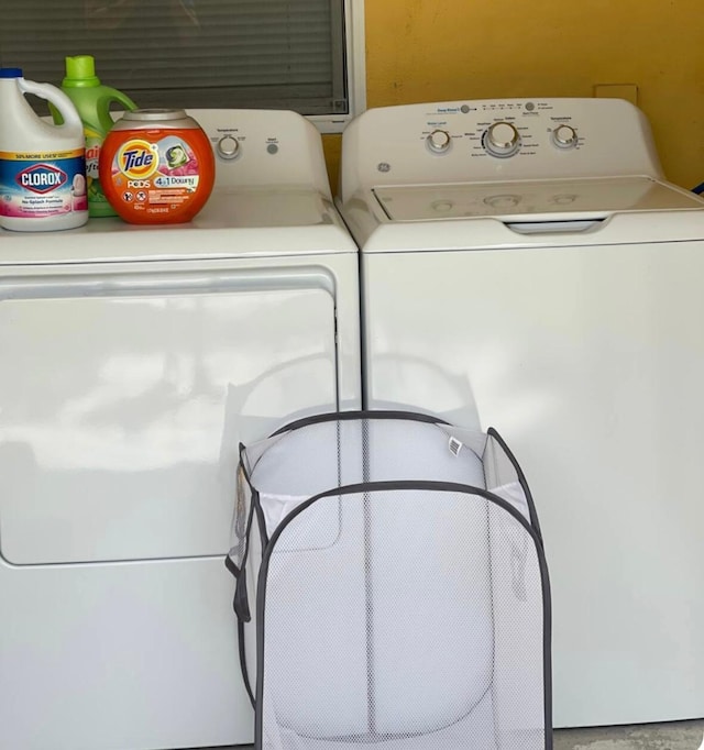 laundry room with washing machine and clothes dryer and laundry area