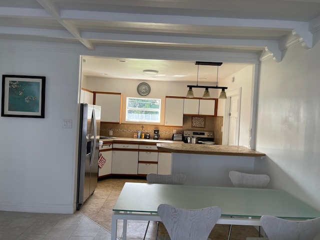 kitchen featuring stainless steel appliances, decorative backsplash, a peninsula, white cabinetry, and light countertops