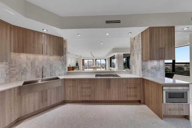 7351 Promenade Dr Unit 801F, Boca Raton, FL 33433 - kitchen featuring modern cabinets, plenty of natural light, a sink, light countertops, and recessed lighting