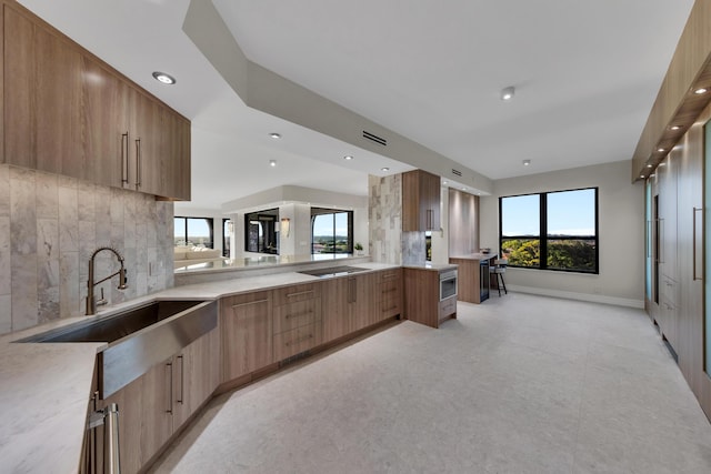 7351 Promenade Dr Unit 801F, Boca Raton, FL 33433 - kitchen featuring modern cabinets, a sink, recessed lighting, light countertops, and decorative backsplash