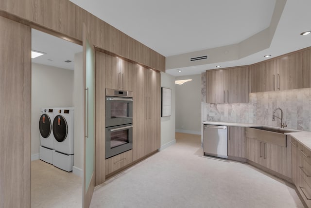 7351 Promenade Dr Unit 801F, Boca Raton, FL 33433 - kitchen featuring appliances with stainless steel finishes, modern cabinets, a sink, separate washer and dryer, and light brown cabinets
