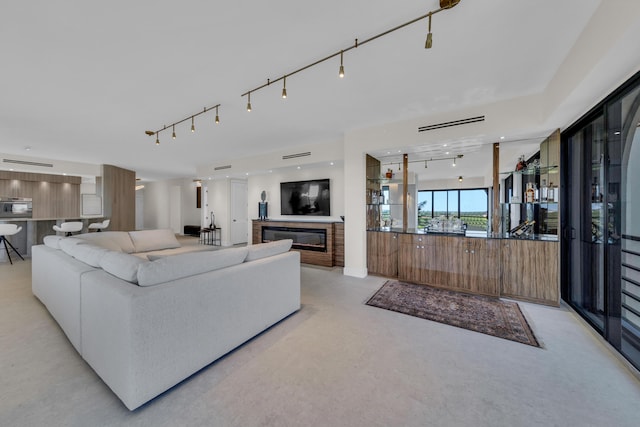 7351 Promenade Dr Unit 801F, Boca Raton, FL 33433 - living room featuring a glass covered fireplace and track lighting