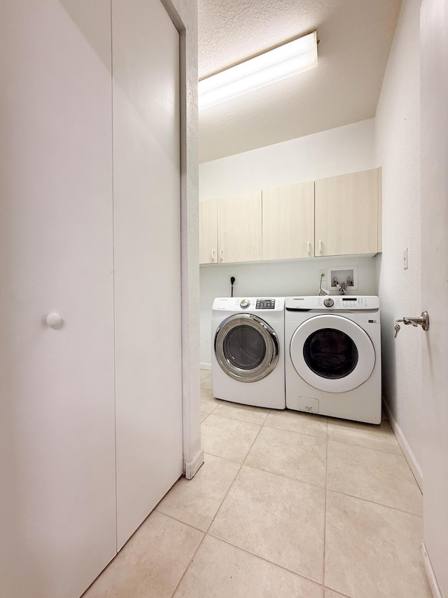 4803 NW 59th Ct, Coconut Creek, FL 33073 - laundry area with cabinet space, light tile patterned floors, washing machine and clothes dryer, and baseboards