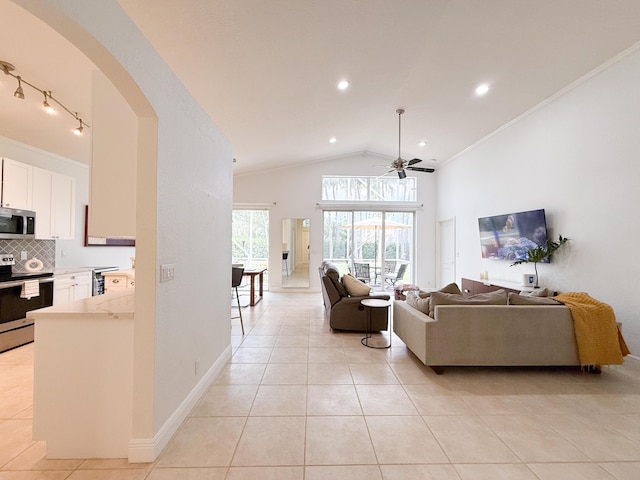 4803 NW 59th Ct, Coconut Creek, FL 33073 - living area with arched walkways, light tile patterned floors, ceiling fan, and vaulted ceiling