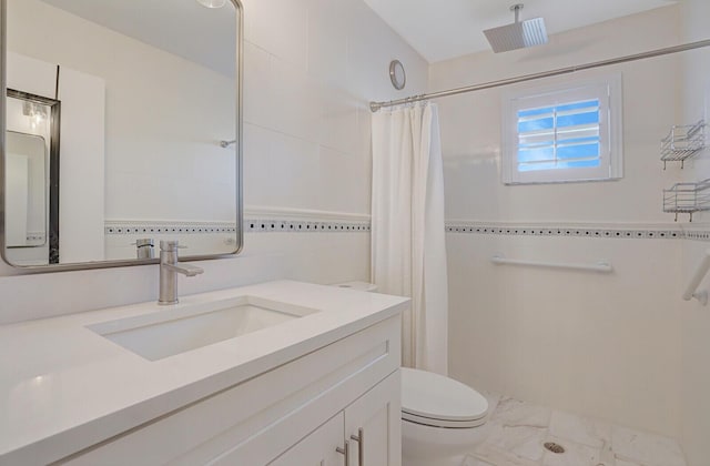 bathroom featuring marble finish floor, toilet, a shower with curtain, and vanity