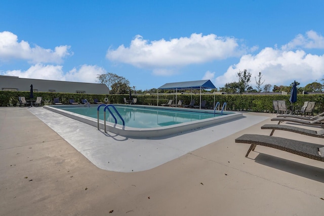 community pool featuring a patio area and fence
