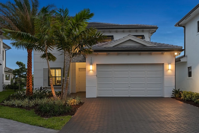 3038 Safflower Cir, West Palm Beach, FL 33401 - view of front of property featuring decorative driveway, stucco siding, a garage, and a tile roof