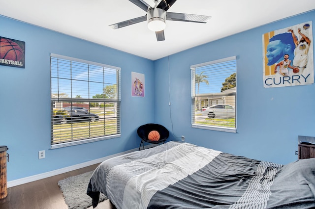 7938 Ridgewood Dr, Lake Worth, FL 33467 - bedroom with wood finished floors, ceiling fan, baseboards, and multiple windows
