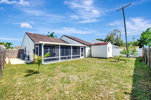 7938 Ridgewood Dr, Lake Worth, FL 33467 - rear view of house featuring a yard, a fenced backyard, an outdoor structure, and a sunroom