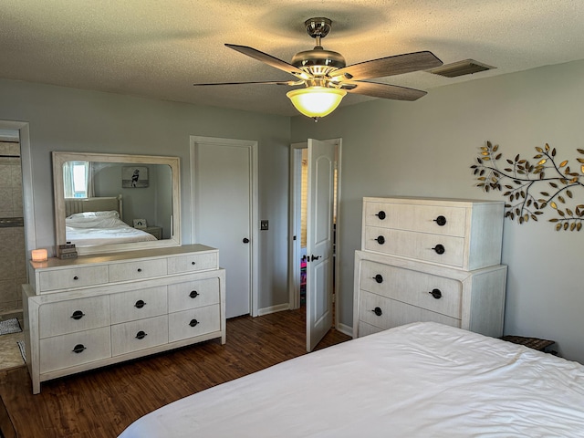 bedroom with visible vents, ceiling fan, a textured ceiling, and dark wood finished floors