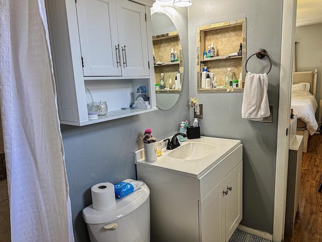 full bathroom featuring vanity, toilet, and wood finished floors