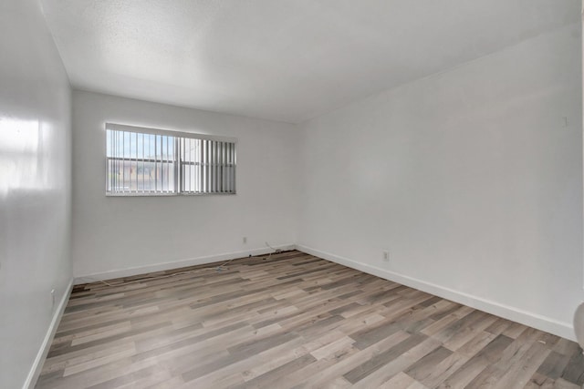 97 Saxony C, Delray Beach, FL 33484 - unfurnished room featuring baseboards and wood finished floors