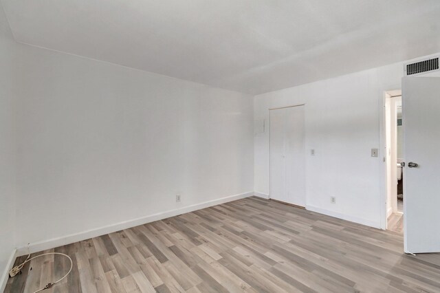 97 Saxony C, Delray Beach, FL 33484 - empty room featuring baseboards, visible vents, and light wood-style floors