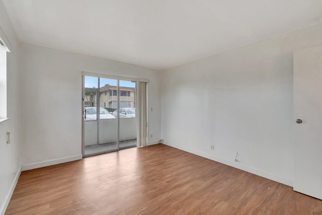 97 Saxony C, Delray Beach, FL 33484 - spare room featuring baseboards and light wood-style flooring