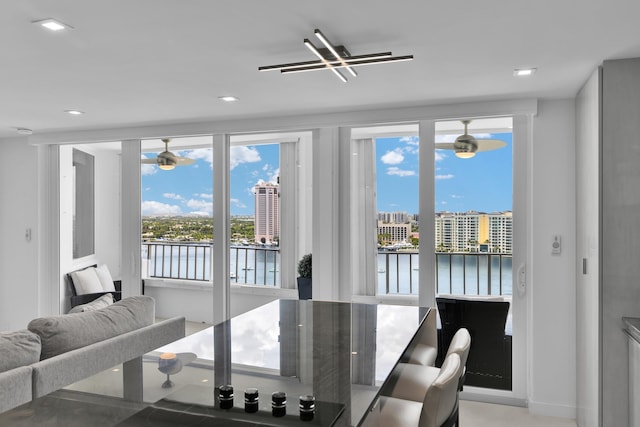 dining space with a water view, a ceiling fan, and recessed lighting