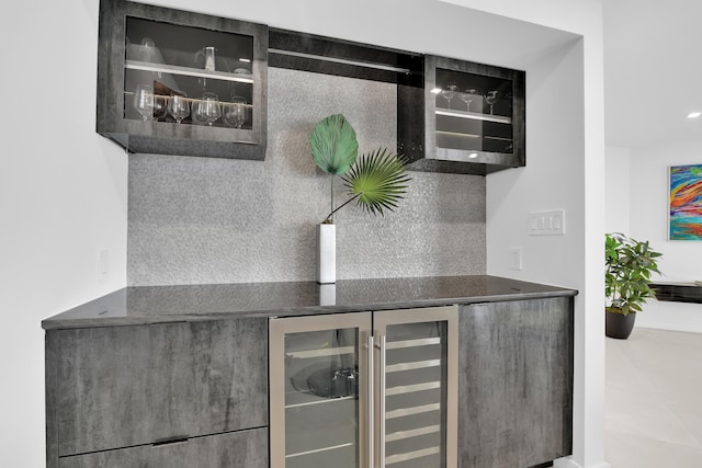 bar with a bar, backsplash, and beverage cooler