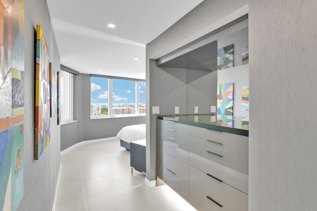 ensuite bathroom featuring baseboards, recessed lighting, connected bathroom, and vanity