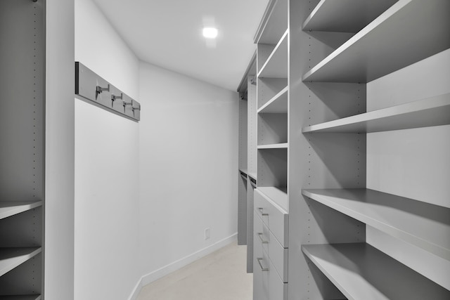 walk in closet with lofted ceiling