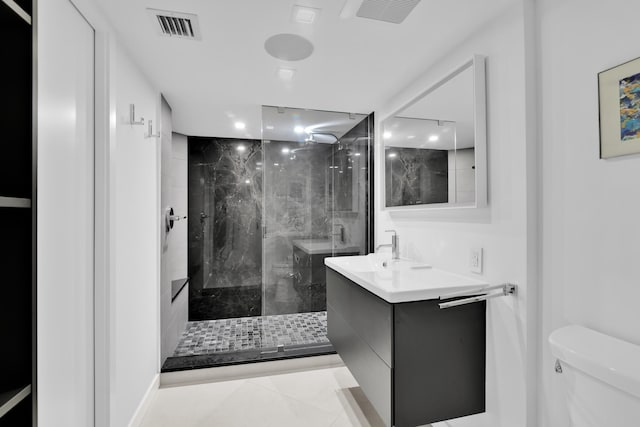 full bath featuring visible vents, a marble finish shower, toilet, and vanity