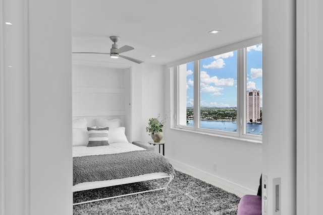 bedroom with baseboards, recessed lighting, and carpet
