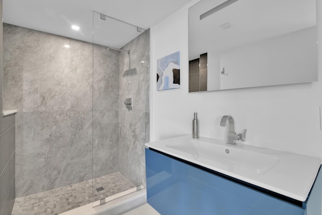 full bathroom featuring a walk in shower and vanity
