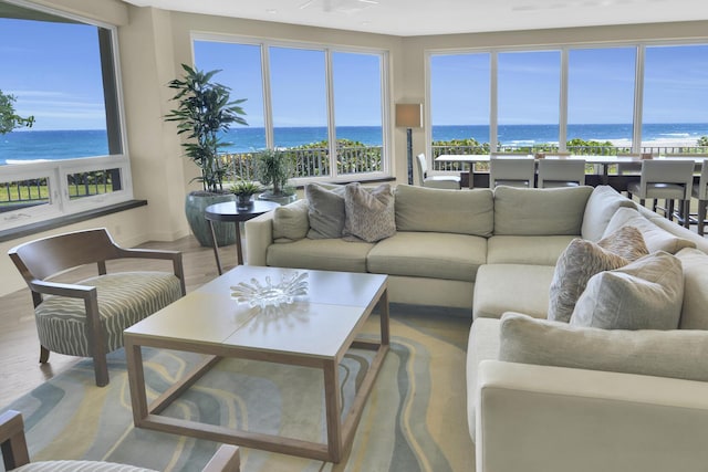 living room featuring a water view, recessed lighting, and wood finished floors