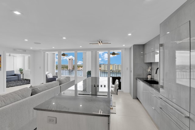 kitchen featuring a center island, a ceiling fan, and modern cabinets