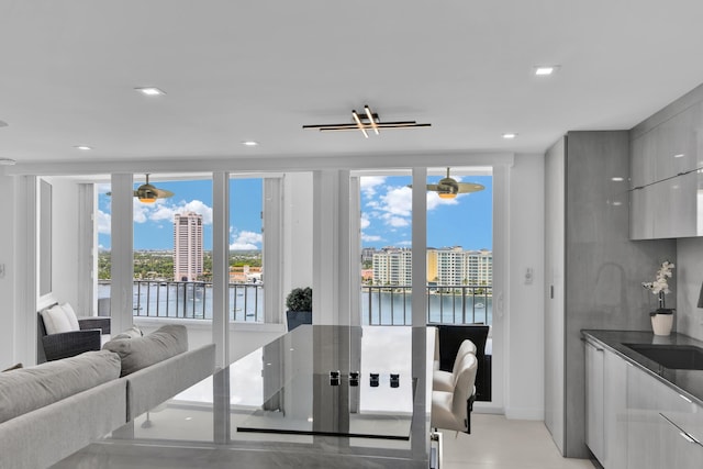 dining area with a water view and recessed lighting