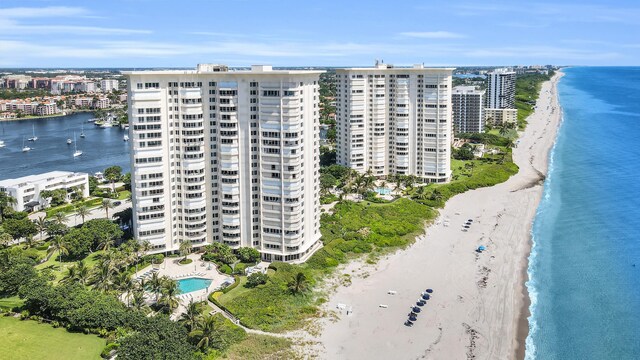 drone / aerial view featuring a water view and a view of the beach