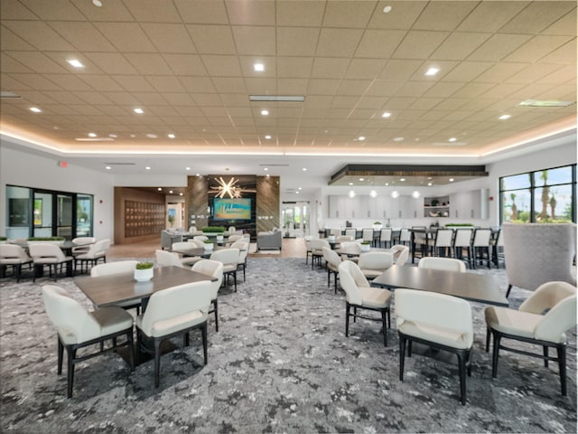 dining space with recessed lighting and a tray ceiling