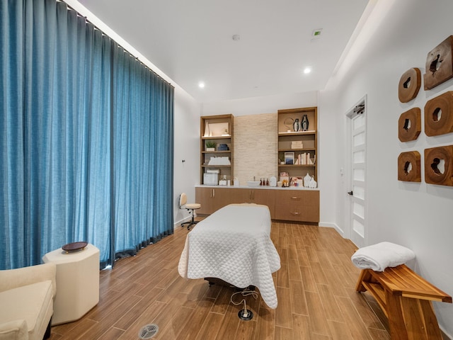 bedroom featuring light wood finished floors, baseboards, and recessed lighting