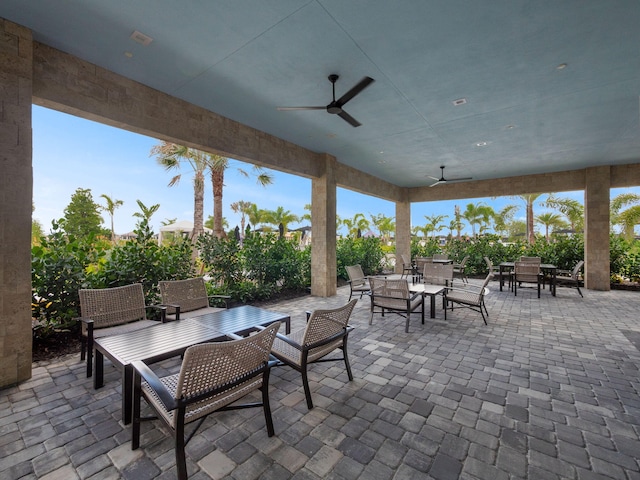 view of patio with outdoor dining space and a ceiling fan