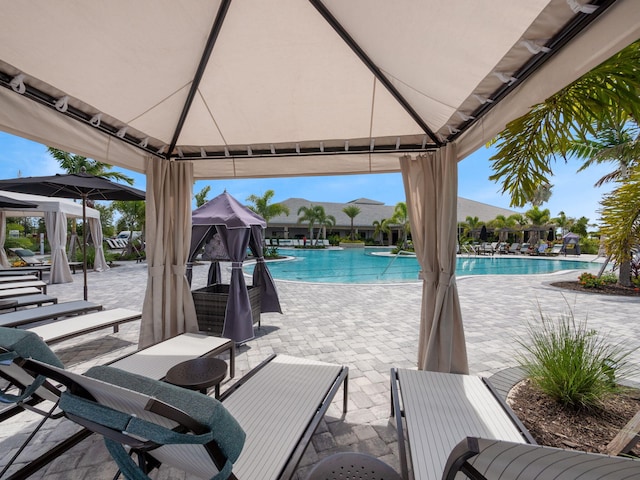 pool featuring a gazebo and a patio area