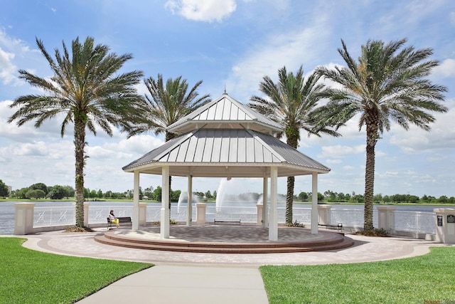 view of home's community with a water view, a gazebo, and a yard