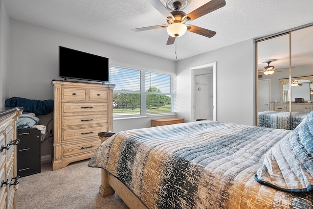 3531 SW Sunset Trace Cir, Palm City, FL 34990 - bedroom with ceiling fan, light colored carpet, and a textured ceiling