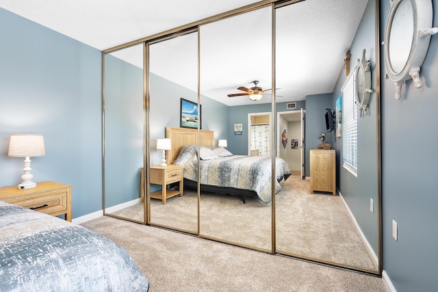3531 SW Sunset Trace Cir, Palm City, FL 34990 - carpeted bedroom with a closet, baseboards, a ceiling fan, and visible vents