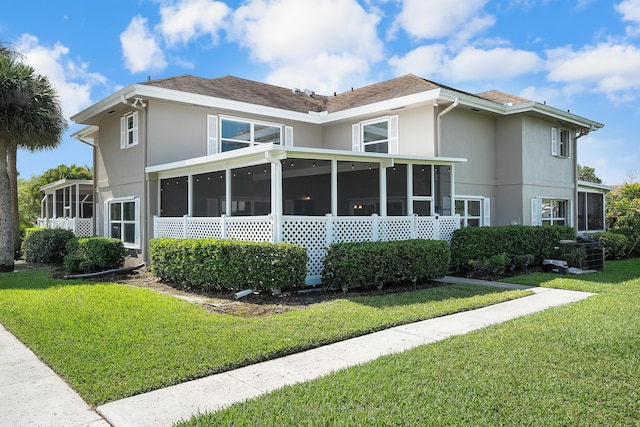 3531 SW Sunset Trace Cir, Palm City, FL 34990 - rear view of house with a yard, stucco siding, and a sunroom