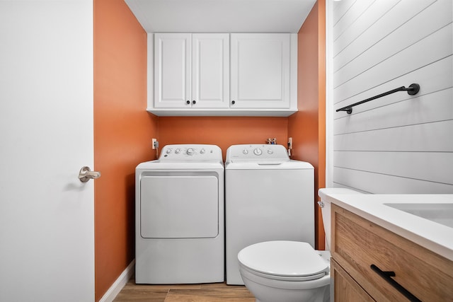 3531 SW Sunset Trace Cir, Palm City, FL 34990 - clothes washing area with washer and dryer, light wood finished floors, and laundry area