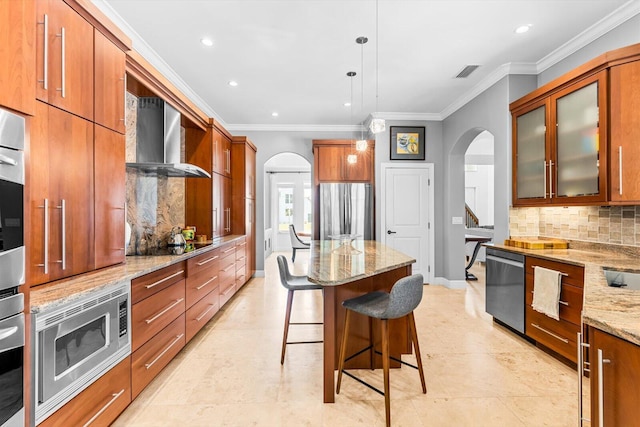 kitchen featuring appliances with stainless steel finishes, visible vents, backsplash, and arched walkways