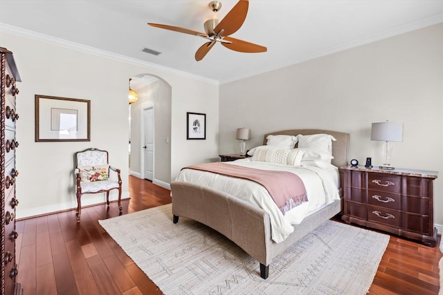bedroom featuring visible vents, arched walkways, crown molding, and dark wood-type flooring