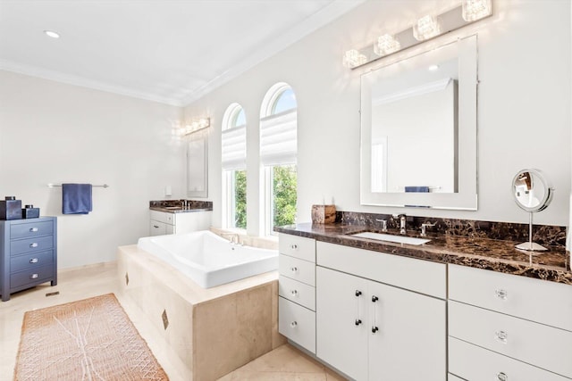 full bathroom featuring crown molding, a sink, two vanities, a bath, and tile patterned flooring