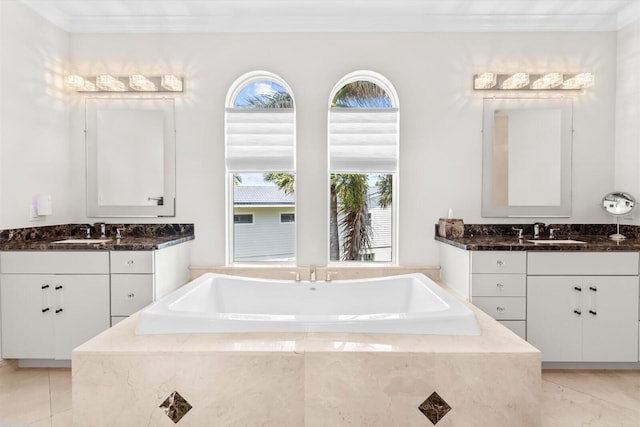 bathroom with two vanities, ornamental molding, and a sink