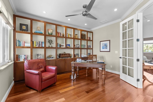 office area with crown molding, french doors, baseboards, wood finished floors, and a ceiling fan