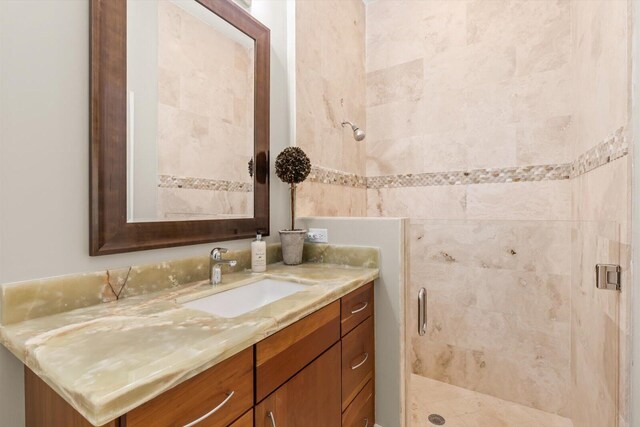 full bath featuring a shower stall and vanity