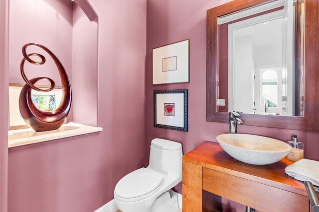 bathroom featuring toilet and vanity