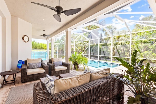 view of patio / terrace with an outdoor pool, a ceiling fan, an outdoor living space, and glass enclosure